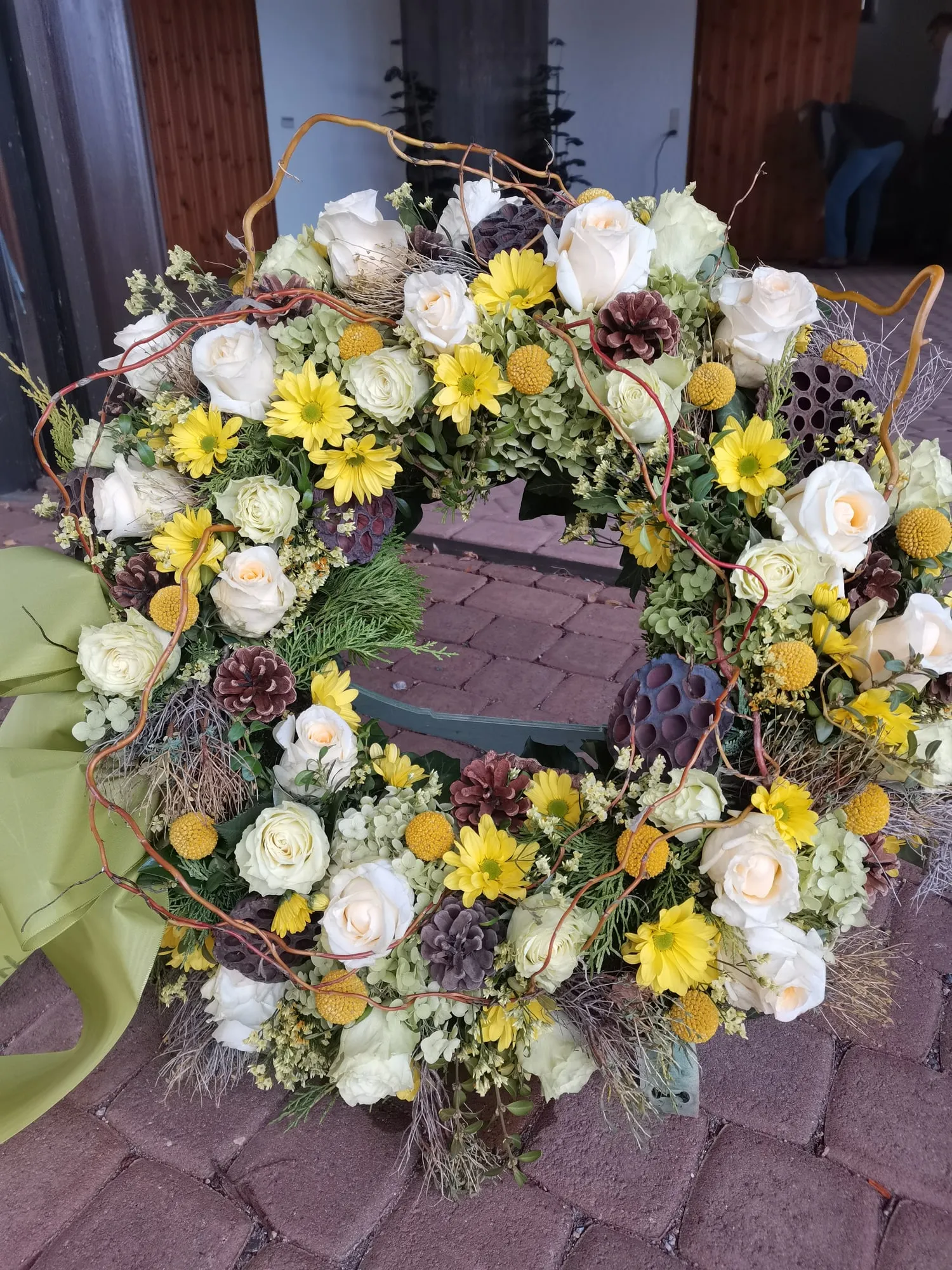 Kranz in Gelb und Weiß mit Zapfen und Trockenblumen